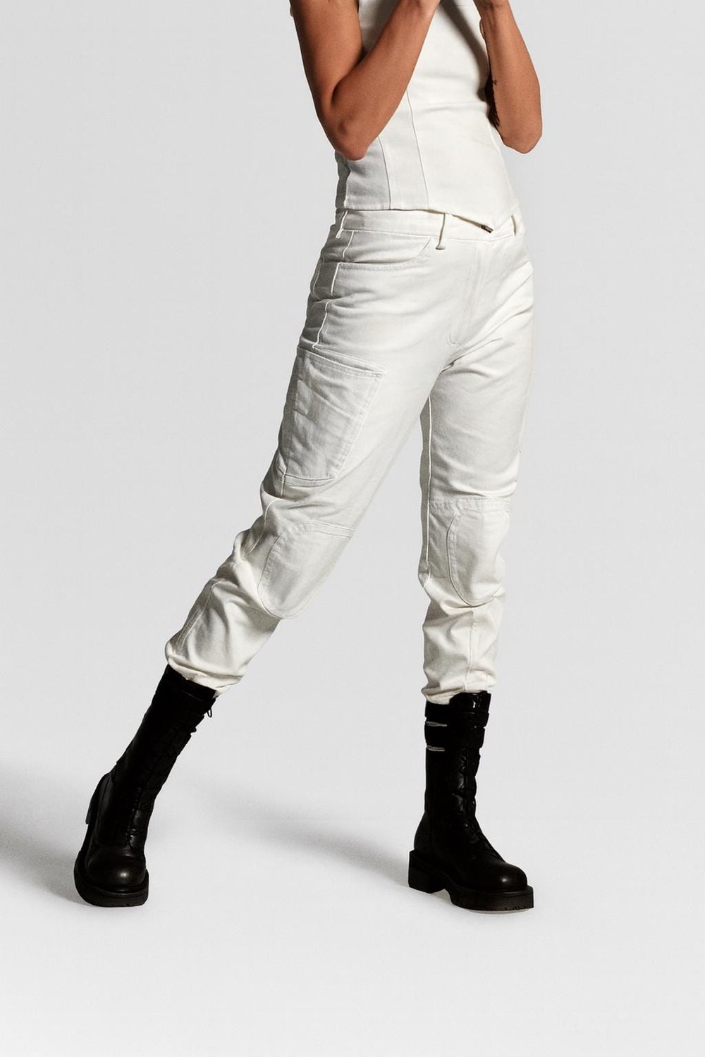 Lunar Ops Cargo — white futuristic cargo pants worn with black boots